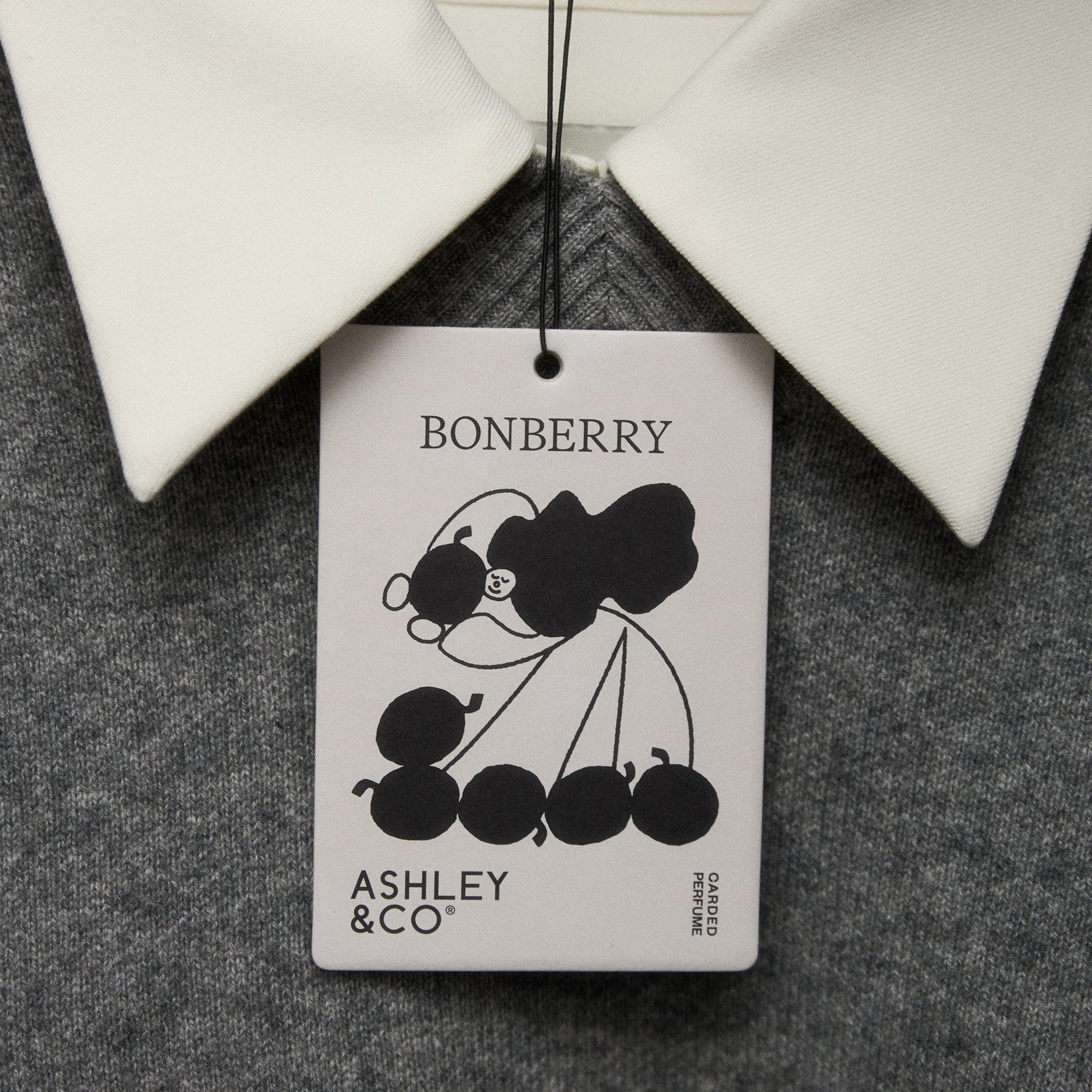 Bonberry Ashley & Co tag on a garment with a gray background