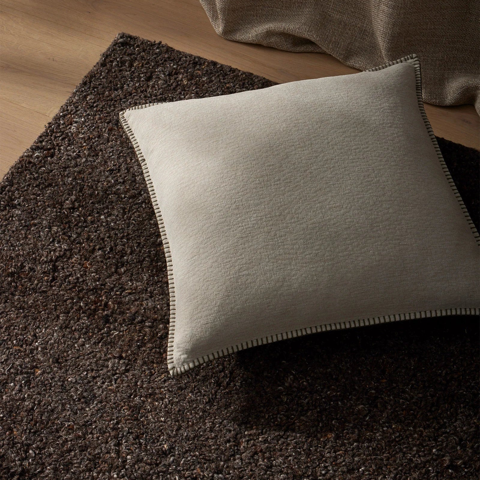 Beige pillow on a textured brown surface