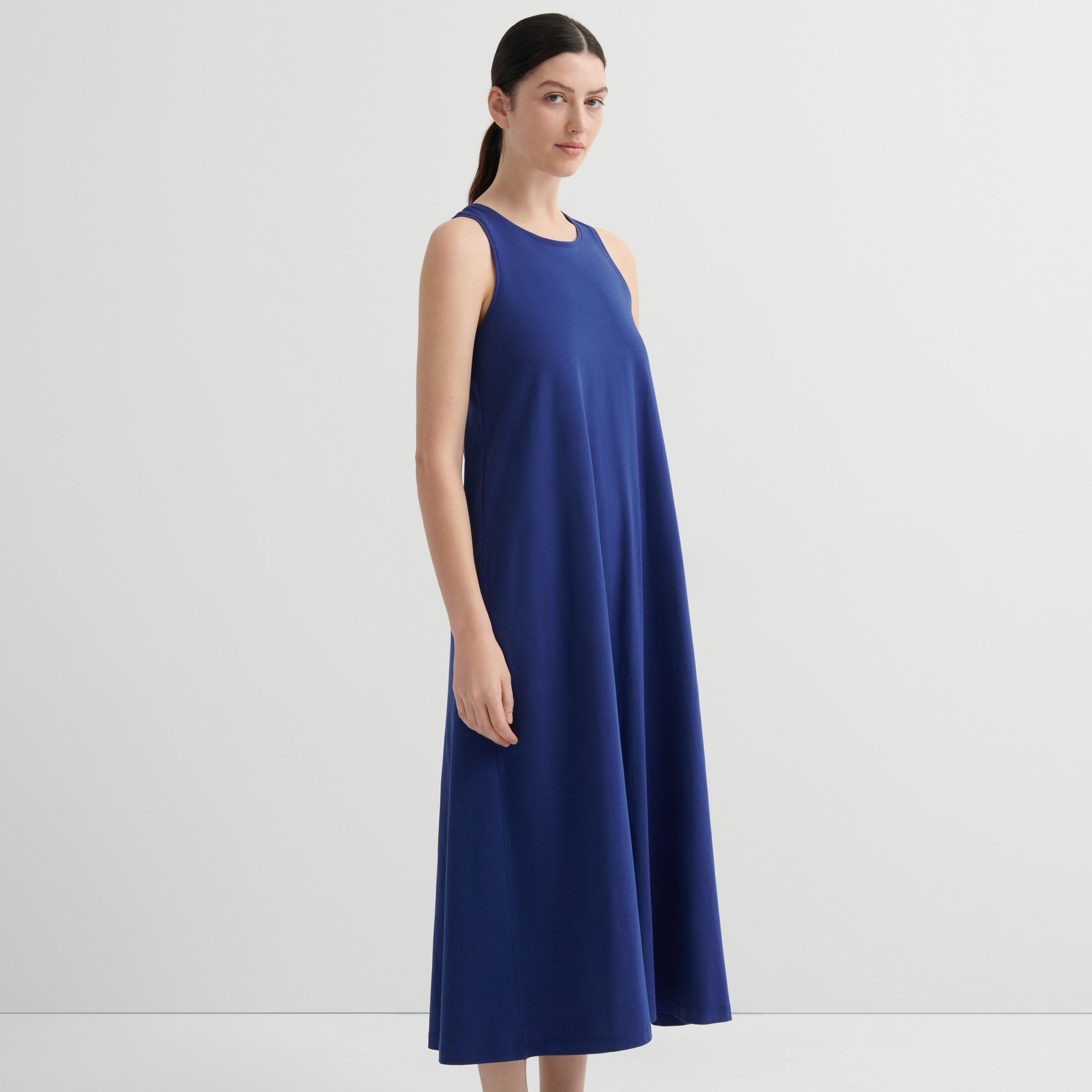 Woman wearing a blue dress against a white background