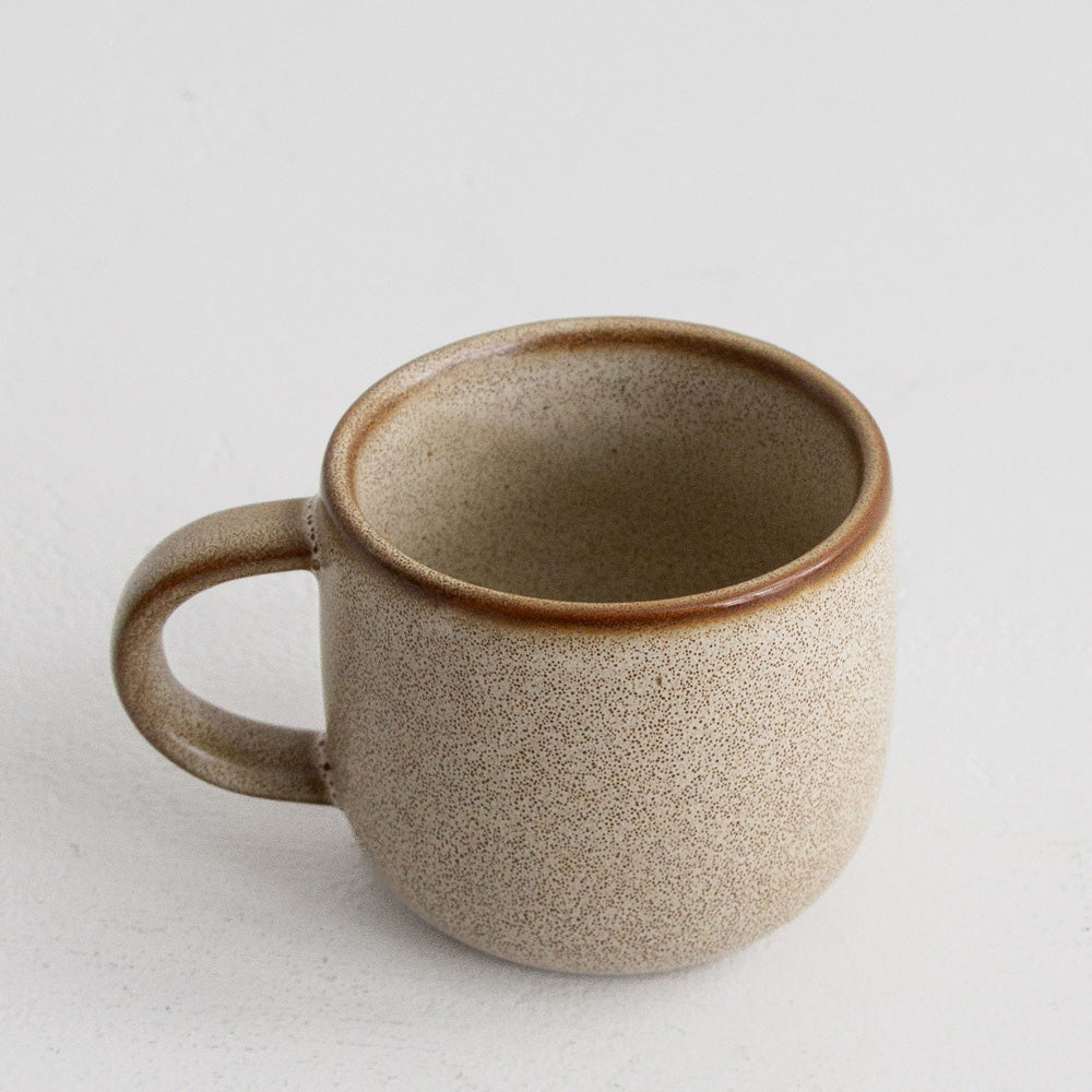 Ceramic mug with a textured surface on a light gray background
